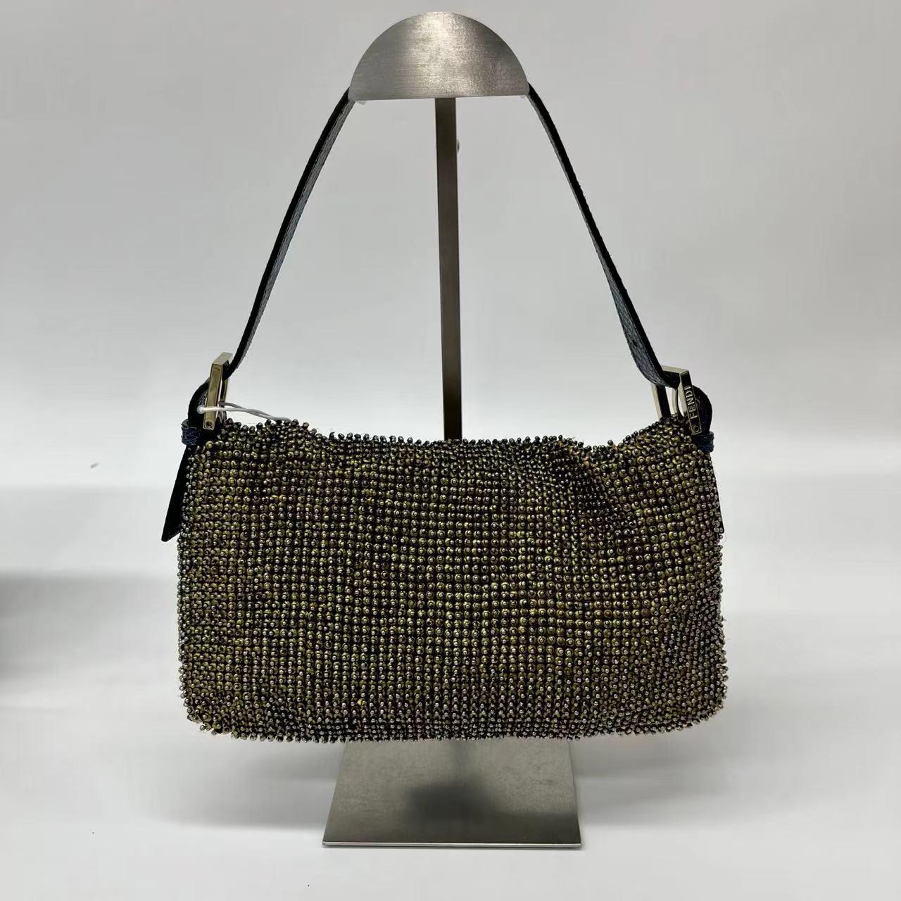 Fendi Baguette Rare Vintage Gold Metallic Beaded Snake-skin Trimmed Shoulder Bag
These are professional photos of the actual bag.
  Discover the Fendi Baguette - a masterfully crafted, iconic design enhanced with metallic gold beads. This exquisite