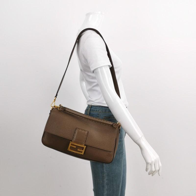Fendi Baguette Selleria Calfskin Leather Crossbody Bag Large Brown
 These are professional photos of the actual bag offered
 Experience luxury and style with the Fendi Baguette in durable calfskin Leather Crossbody Bag. Crafted from calfskin leather