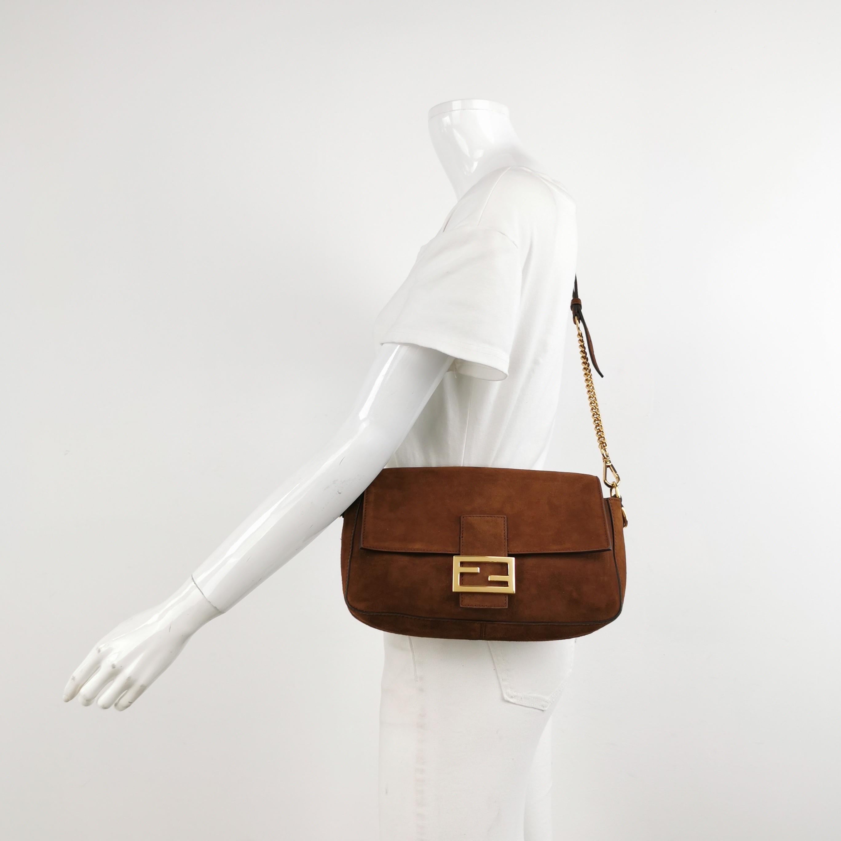 Fendi Baguette Selleria Suede Leather Crossbody Bag Medium Caramel Tan
 These are professional photos of the actual bag.
 Experience luxury and style with the Fendi Baguette in durable calfskin Leather Crossbody Bag. Crafted from calfskin leather
