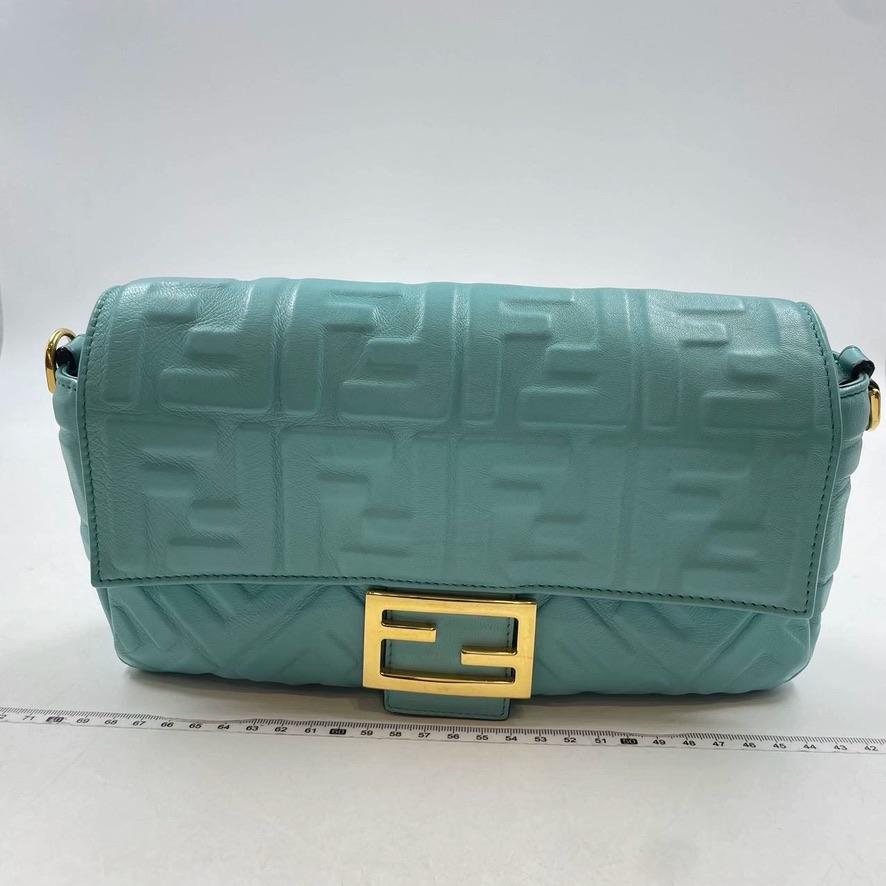 Iconic medium Baguette bag made of this stunning turquoise color soft nappa leather with a three-dimensional texture FF motif. Decorated with an FF clasp.
Featuring a front flap, magnetic clasp, lined internal compartment with zip pocket and