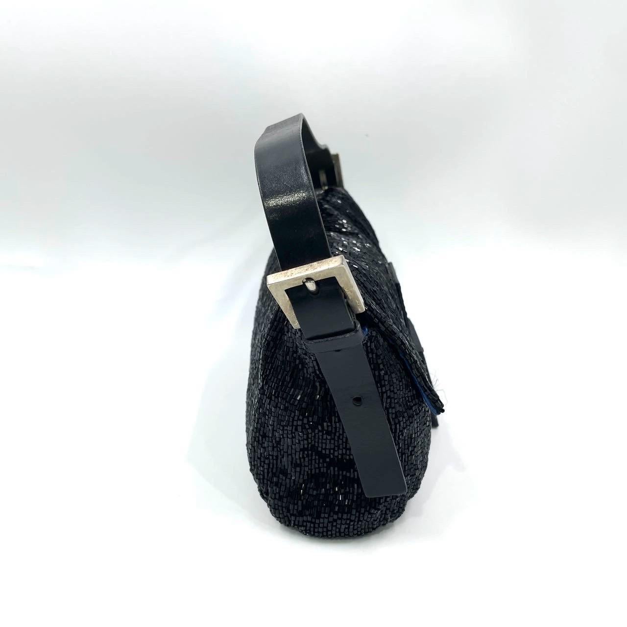 Discover the Fendi Baguette Vintage Black Glitter Beads - a masterfully crafted, iconic design enhanced with shimmering beads. This exquisite piece of art is versatile and can elevate any outfit, making it a timeless addition to your