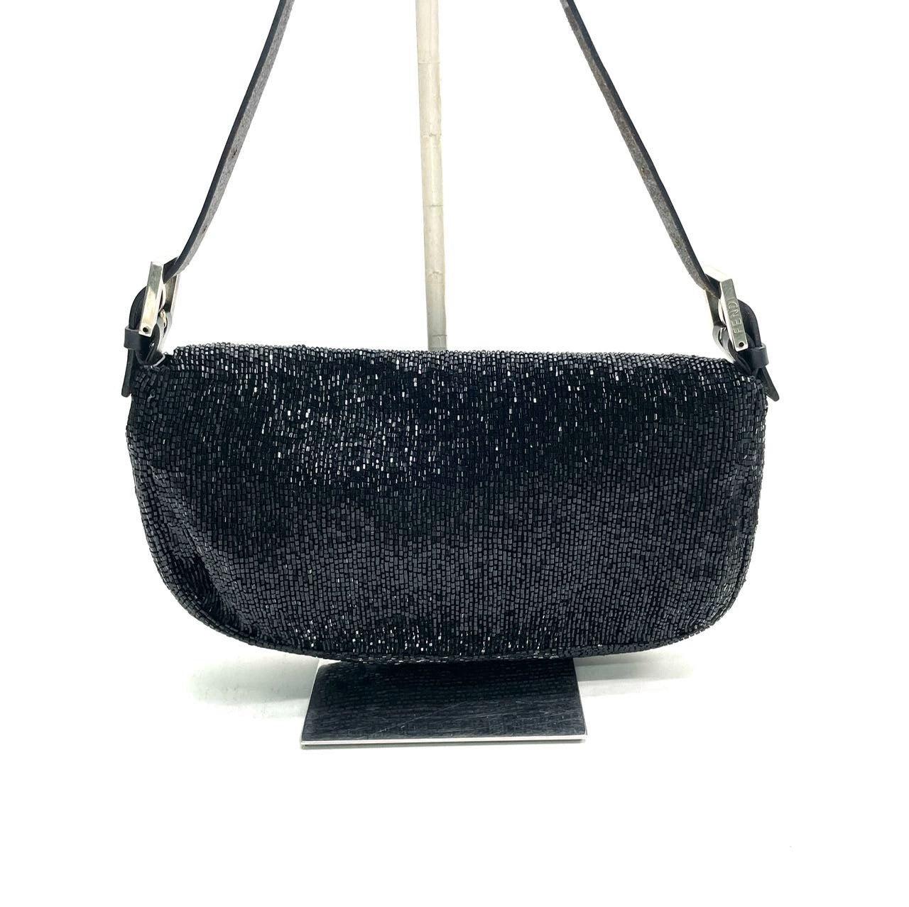 Fendi Baguette Vintage Black Glitter Beads Shoulder Bag

  Discover the Fendi Baguette Vintage Black Glitter Beads - a masterfully crafted, iconic design enhanced with shimmering beads. This exquisite piece of art is versatile and can elevate any