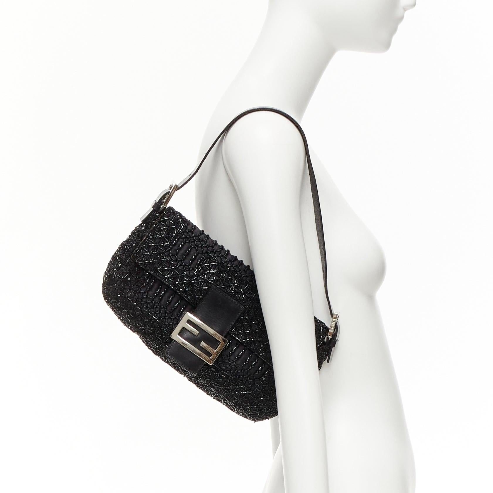 FENDI Baguette Vintage black intricate beaded FF logo black leather buckle bag
Reference: TGAS/D01136
Brand: Fendi
Model: Baguette
Material: Fabric, Leather
Color: Black, Silver
Pattern: Crystals
Closure: Snap Buttons
Lining: Brown Fabric
Extra