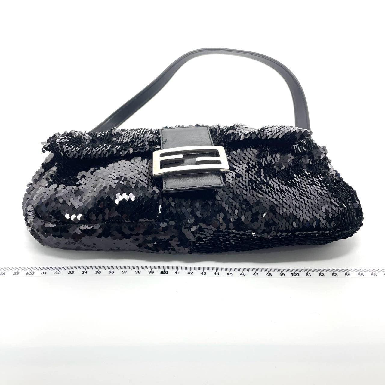 Fendi Baguette Vintage Black Sequins and Leather
  These are professional photos of the actual bag offered by Luxbags.
  This Fendi Baguette definitely stands out from the crowd. Crafted with shimmering black sequins and siover hardware, it sparkles