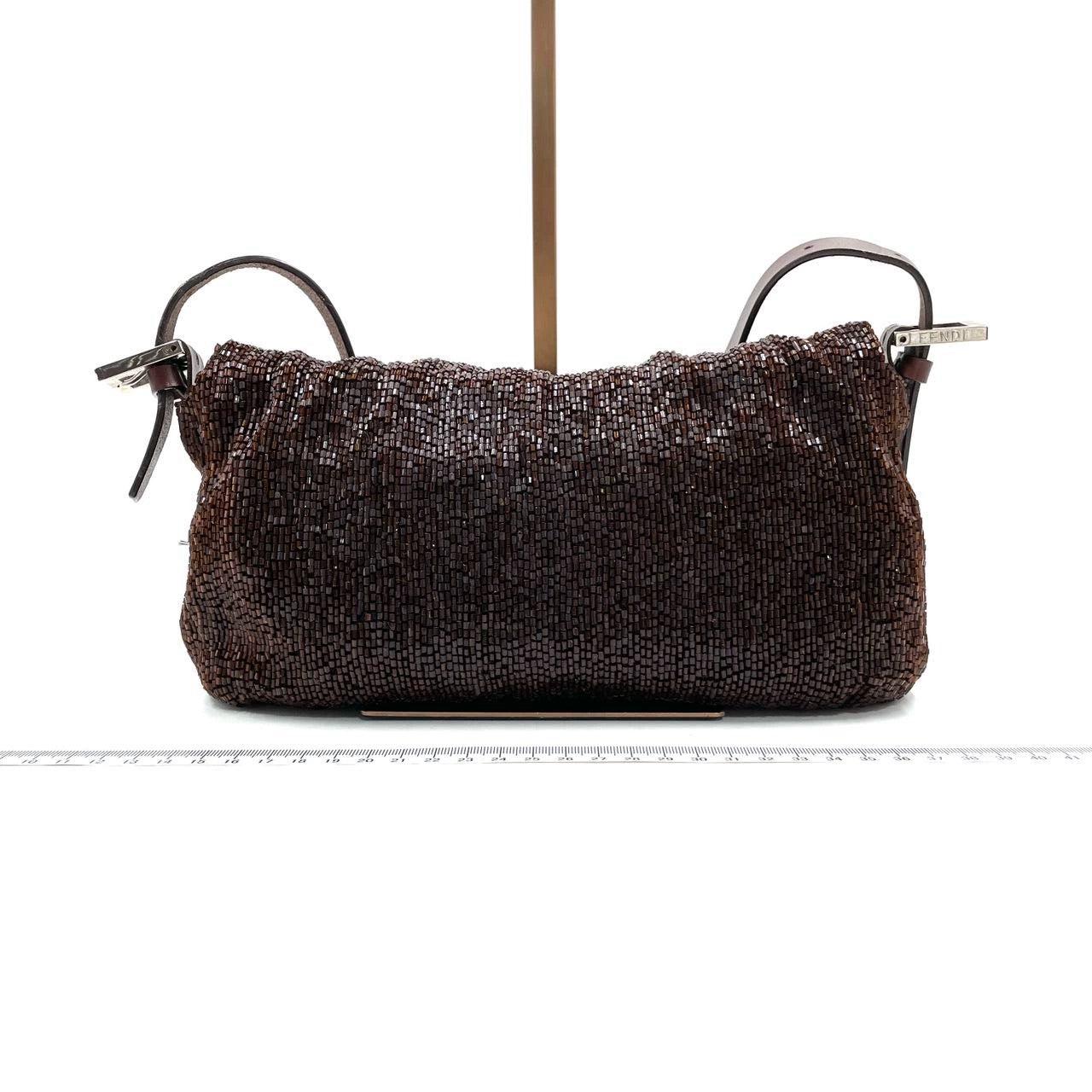 Fendi Baguette Vintage Dark Chocolate Brown Glitter Beads

  Discover the Fendi Baguette Vintage Chocolate Brown Glitter Beads - a masterfully crafted, iconic design enhanced with shimmering beads. This exquisite piece of art is versatile and can