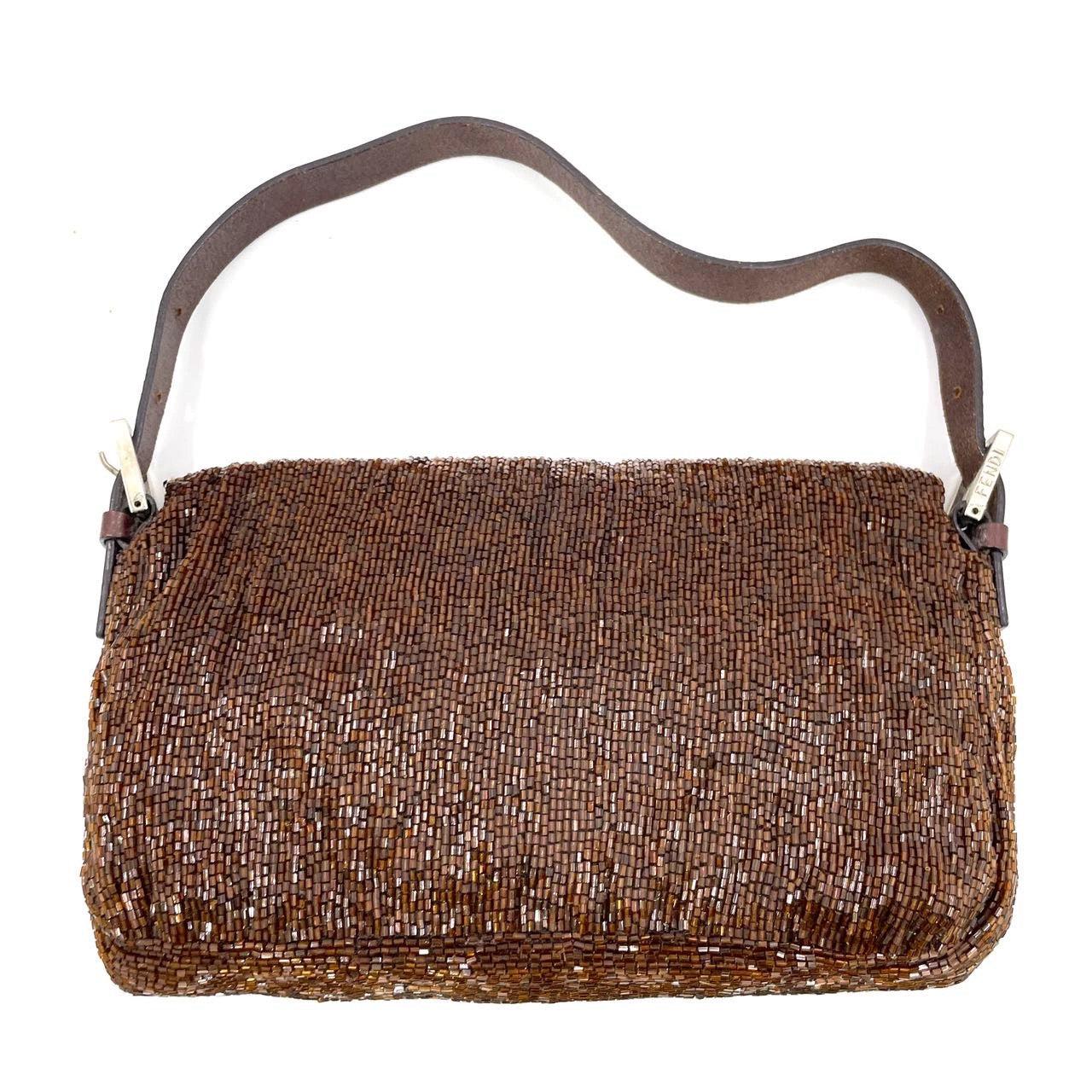 Fendi Baguette Vintage Dark Chocolate Brown Glitter Beads
These are professional photos of the actual bag.
Discover the Fendi Baguette Vintage Chocolate Brown Glitter Beads - a masterfully crafted, iconic design enhanced with shimmering beads. This
