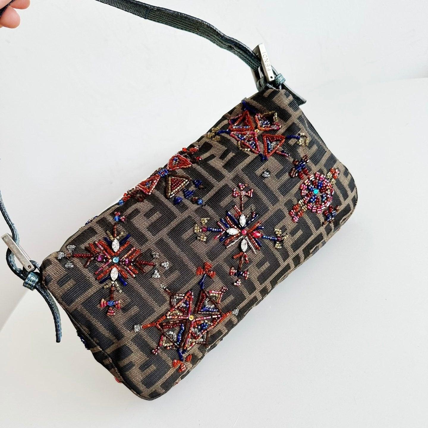 Fendi Baguette Zucca Monogram with Beaded Floral Embroidery
These are professional photos of the actual bag.
  CONDITION: EXCELLENT
  There may be a couple of beads missing at places but overall in excellent condition. 
  DETAILS
  
  Fendi
 