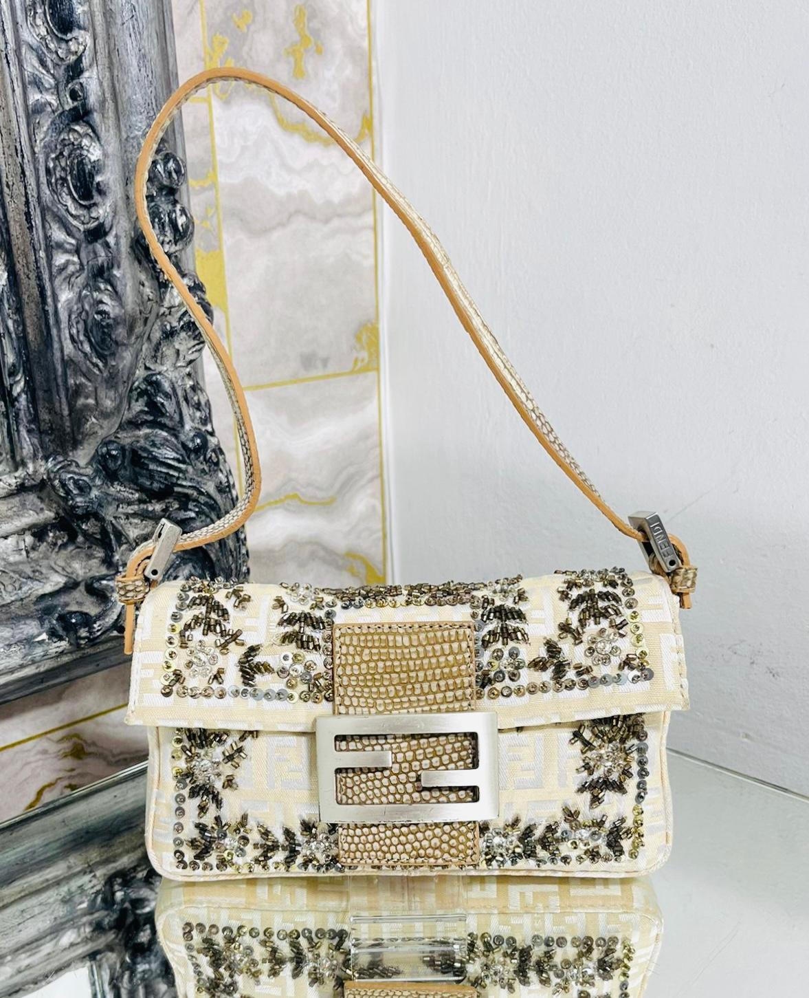 Fendi Bead Embroidered Canvas & Snakeskin 'FF' Logo Baguette Bag

Ivory shoulder bag designed with brown and beige bead embroidery on 'FF' logo printed canvas.

Styled with silver 'FF' logo snap closure with leather detail and adjustable shoulder