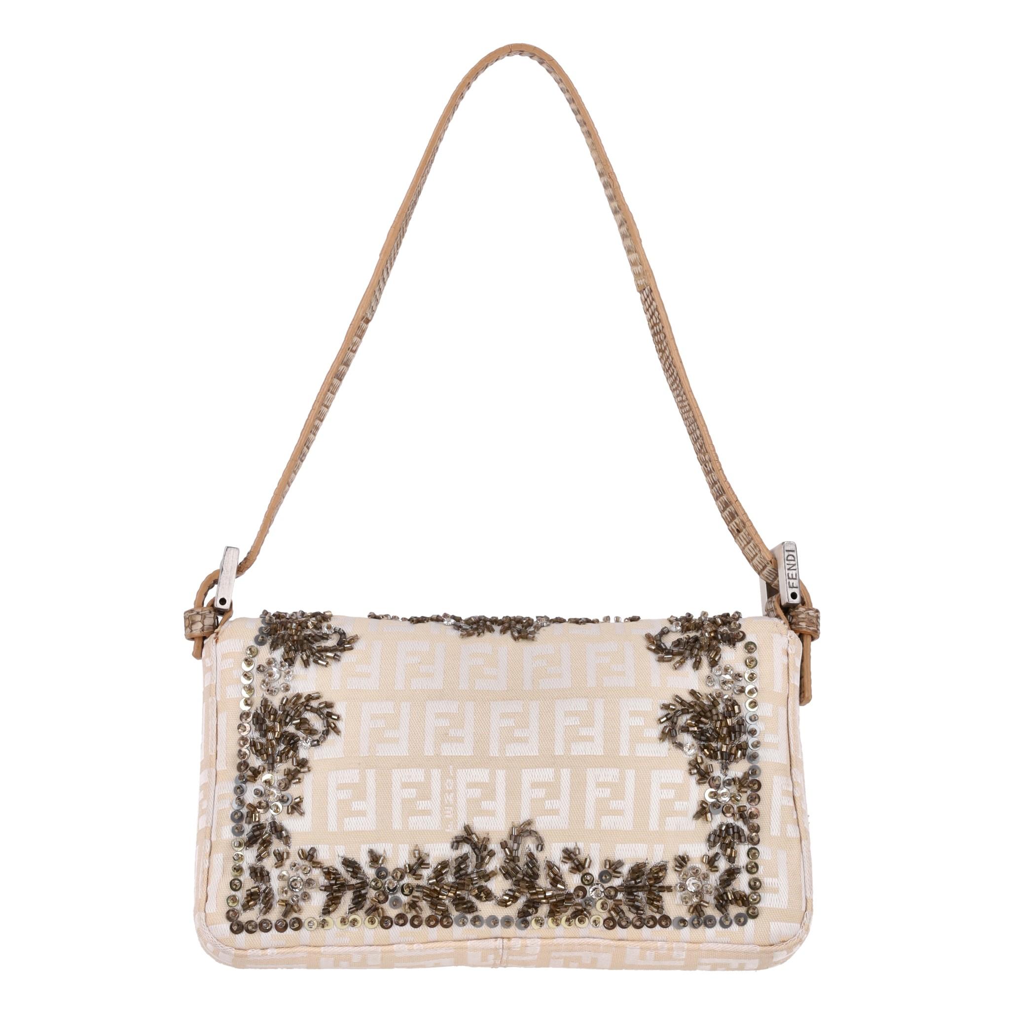 Fendi Bead Embroidered Canvas Snakeskin 'FF' Logo Baguette Bag

Ivory shoulder bag designed with brown and beige bead embroidery on 'FF' logo printed canvas.

Silver 'FF' logo snap closure with leather detail and adjustable shoulder