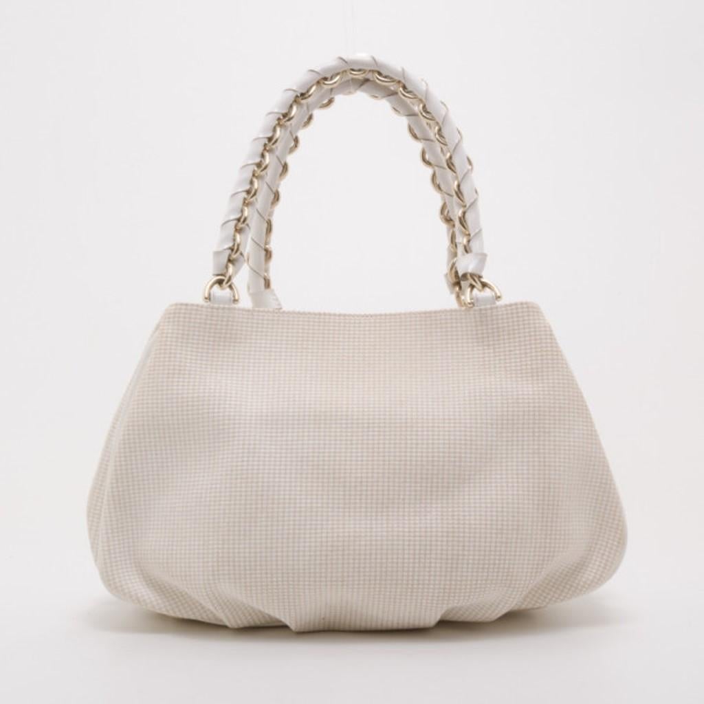 Finish any look with this sophisticated Beige and White Zucca Mia Hobo by Fendi. Made from pleated beige woven fabric with white leather piping, the exterior features a large silver Fendi logo, and double leather wrapped chain link handles. The