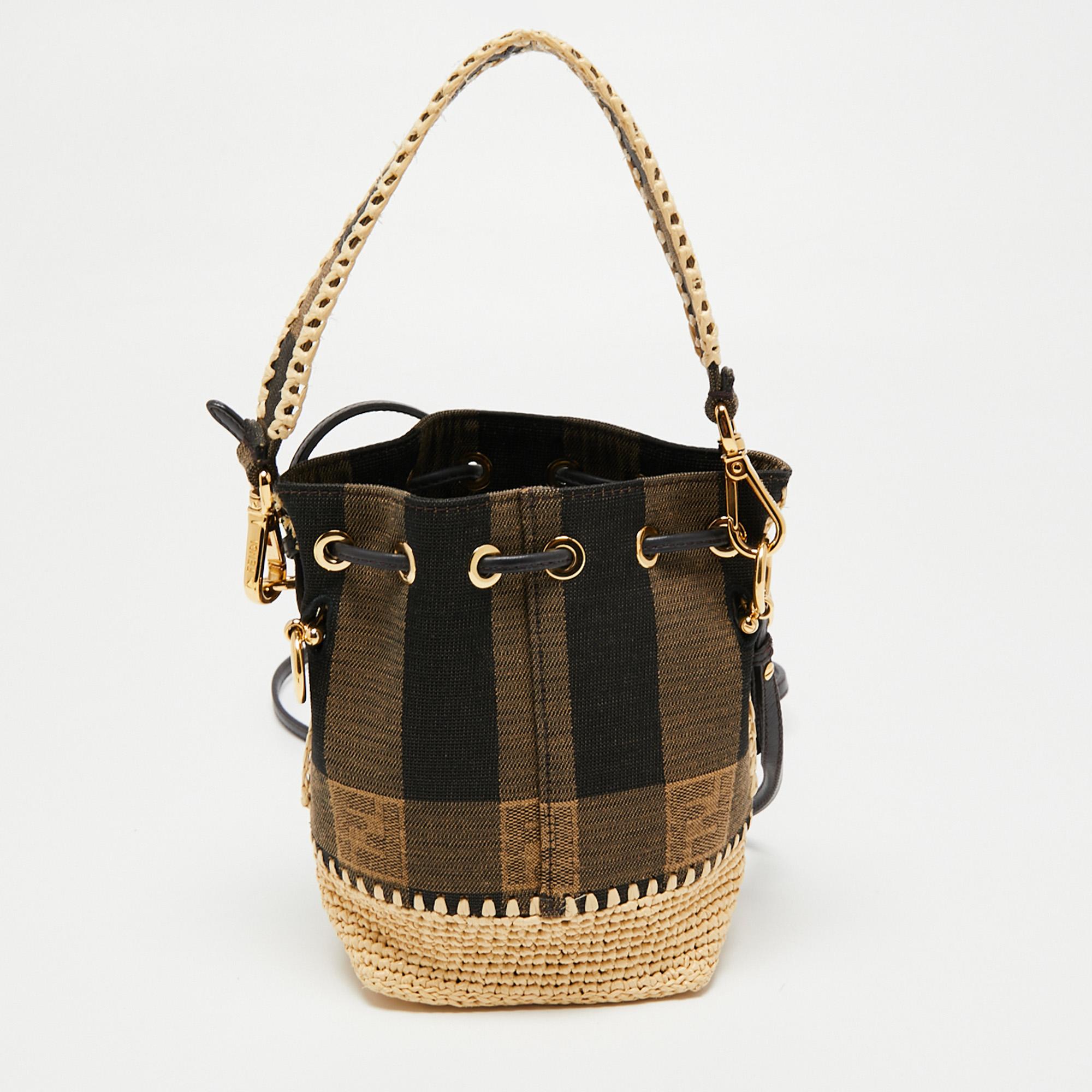 This wonderful Fendi design is made from Pequin canvas and enhanced with gold-tone hardware. The bag has a bucket shape with a drawstring closure that secures the interior. It is complete with a single handle and a shoulder strap.

Includes: