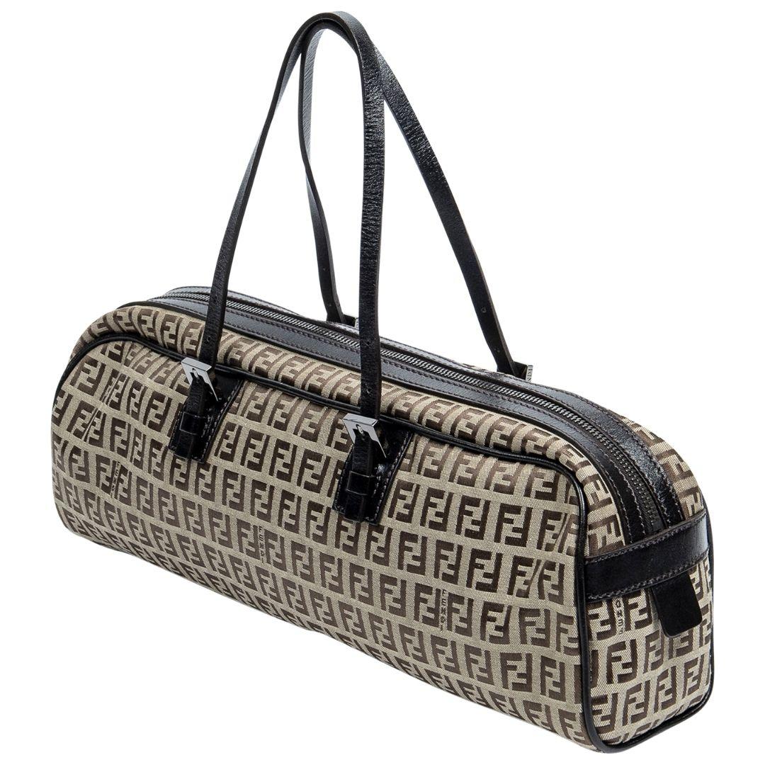I'm in love with the SHAPE of you! This trendy East West Boston Fendi is detailed in the fashion house's archetypal zuchinno canvas with leather trim, silver-tone hardware, and dual top handles. The zippered closure opens to a logo jacquard canvas