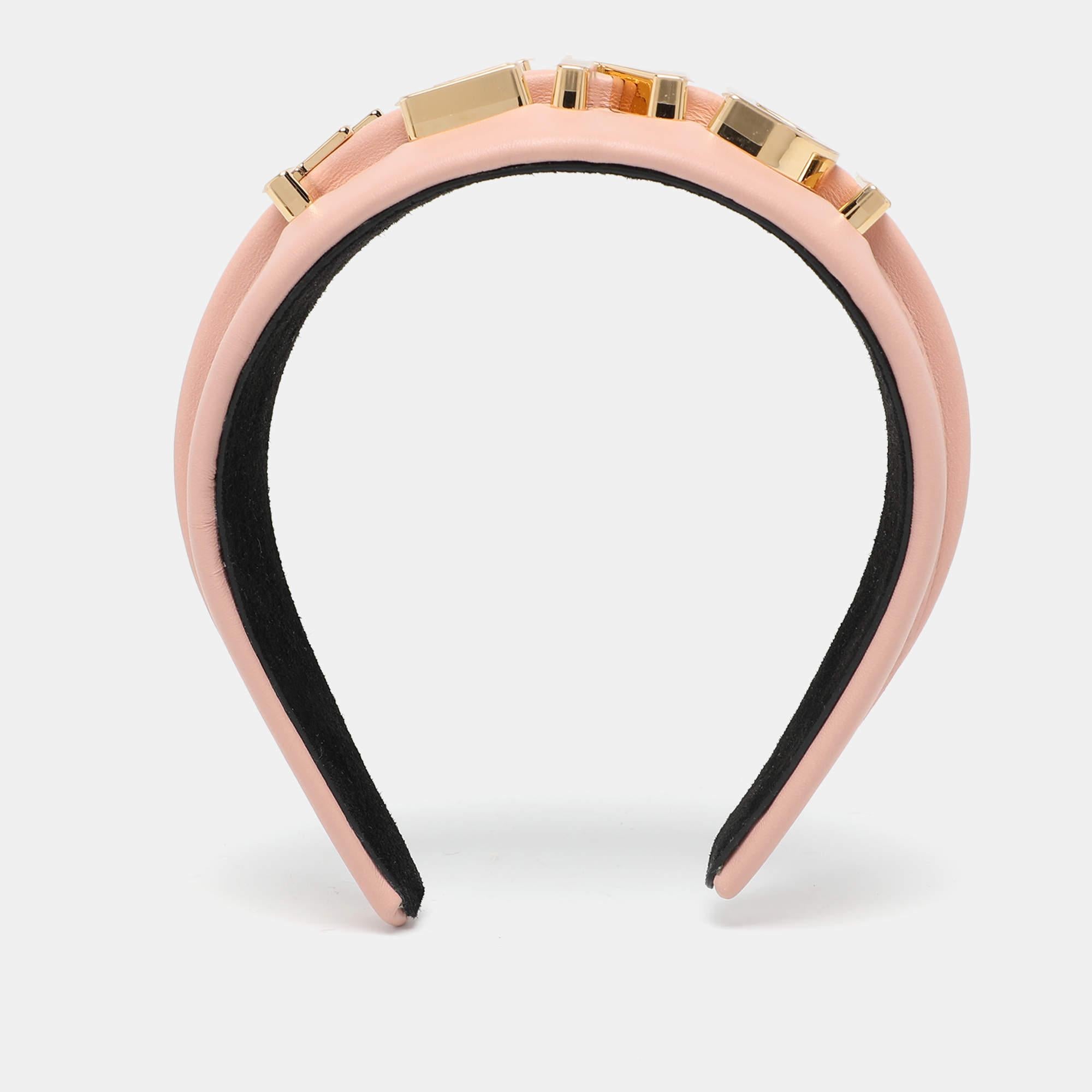 The Fendi headband adds a touch of refined style to your look. Crafted from smooth beige leather it showcases Fendis signature design elements making it a versatile accessory. Whether paired with casual or formal outfits this headband offers both