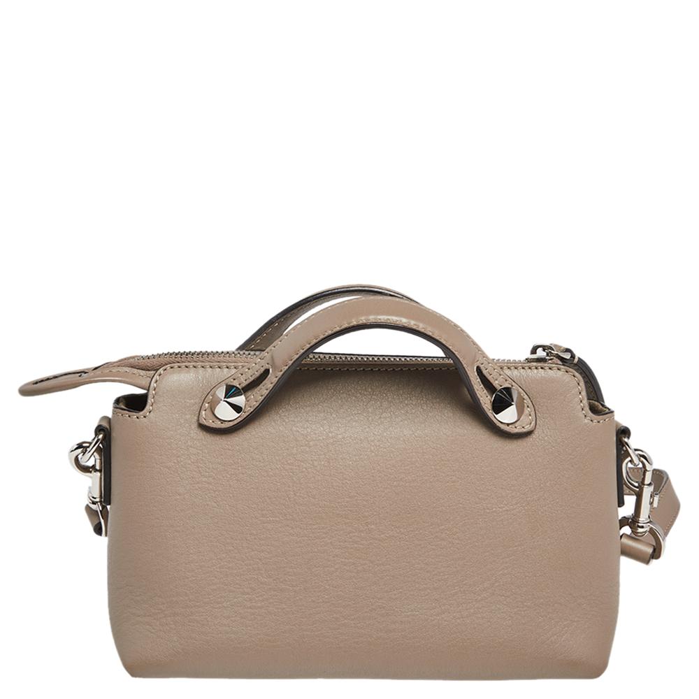 This By The Way bag by Fendi sweetly embodies luxe elegance. Crafted from beige leather in a unique shape, this bag flaunts the brand's expertise in designing high-end goods and upscale styles. The interior is lined with fabric, while the dual