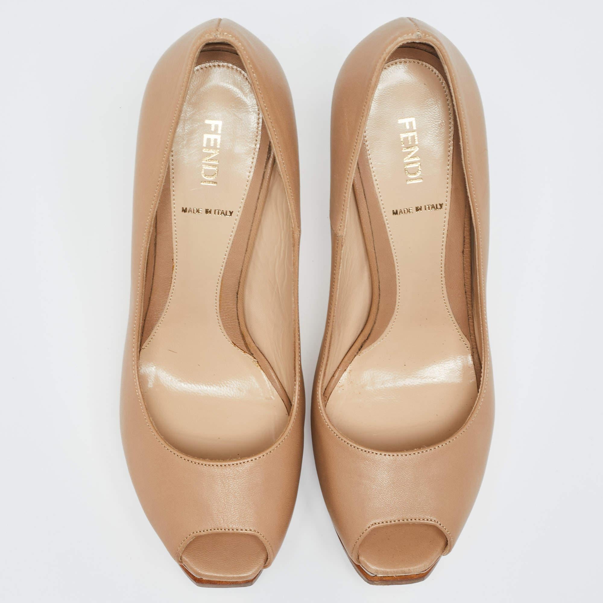 You will always be style-ready when you flaunt these pumps from Fendi. They have been crafted from beige leather in a peep-toe shape. Logo-detailed platforms and high stiletto heels complete this pair.

Includes: Original Dustbag

