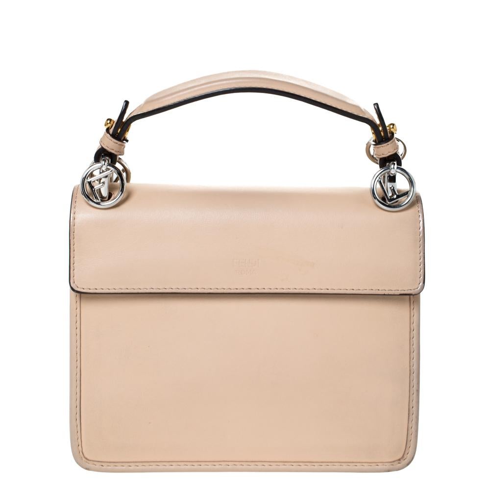 Fendi brings you this bag that is overflowing with style. Crafted from leather, the bag brings the signature F and the flap leads to a suede compartment sized to dutifully hold all your necessities. The beige bag is finished with a top handles and a