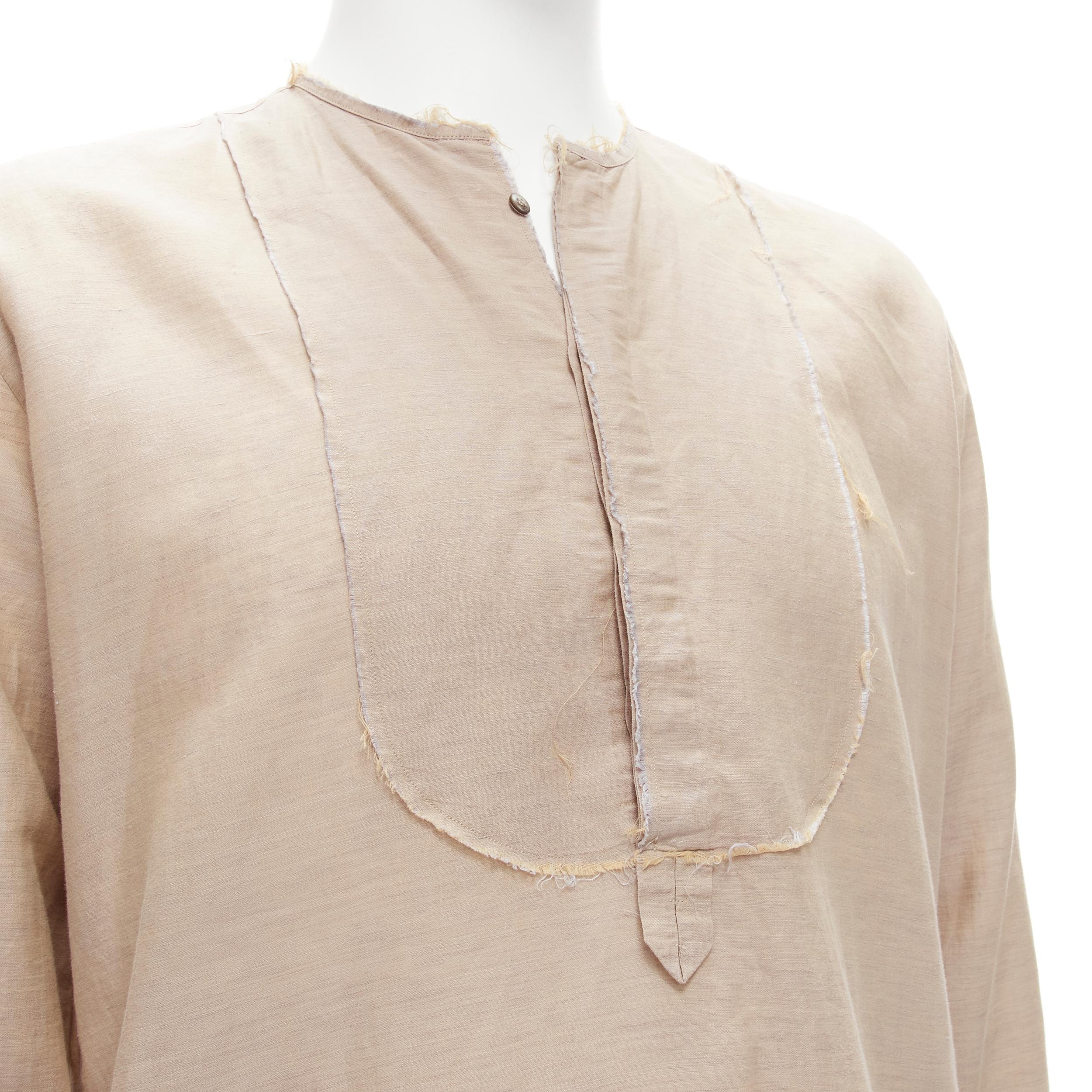 FENDI beige linen cotton raw frayed half button long sleeve shirt EU40 L 
Reference: CNLE/A00173 
Brand: Fendi 
Material: Linen 
Color: Beige 
Pattern: Solid 
Closure: Button 
Extra Detail: Button collar. Raw frayed trim. Dual side pockets. 
Made