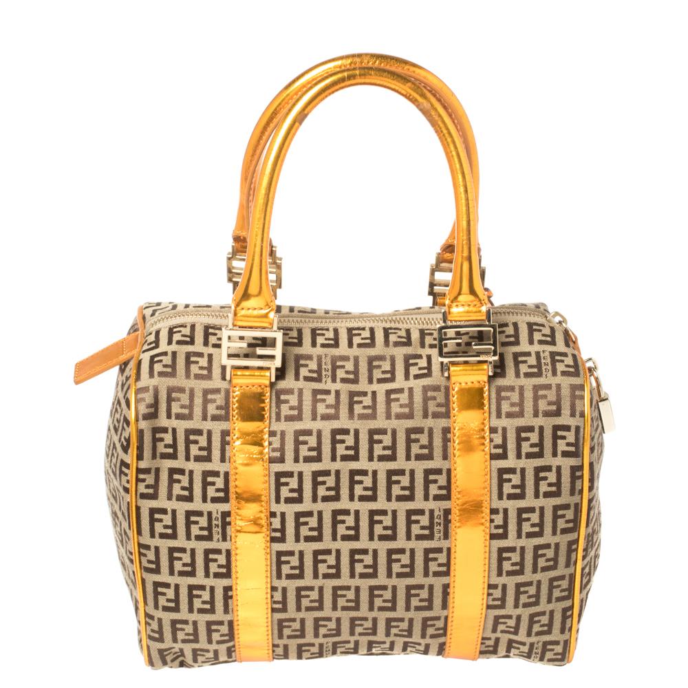 This elegant Forever Bauletto bag from Fendi is crafted from Zucchino coated canvas and is perfect for your fashionable outings. The beautiful bag features splendid details in the form of patent leather trims, dual top handles, and the padlock. The