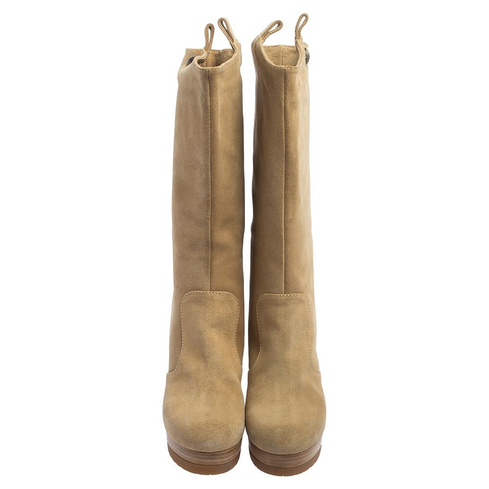 Fendi's knee-high boots are made from soft beige suede, so the styling options are endless. They have round toes, pull tabs, high heels supported by platforms. Style them with short hemlines to highlight these chic boots.

Includes: Price Tag,