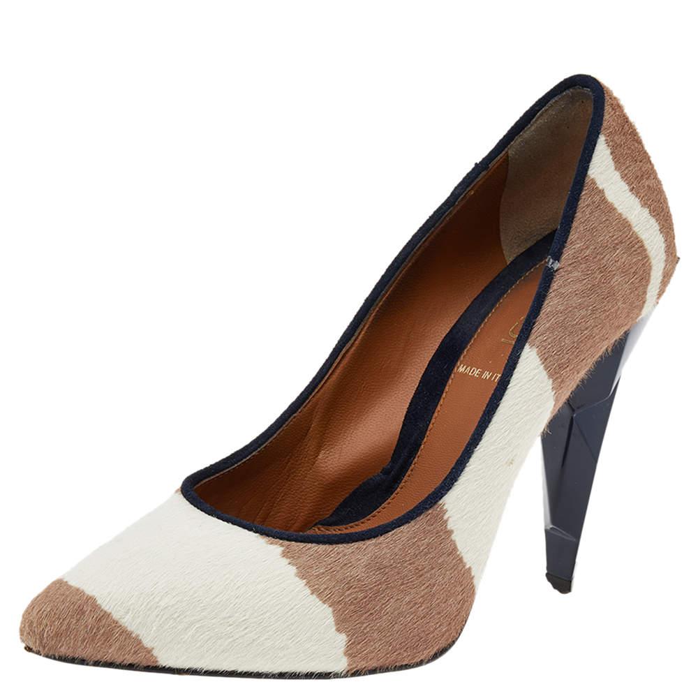 Make a luxe addition to your look by donning these calf hair pumps. The plush design of these classic pumps is finished with a set of diamond heels. Pair the pumps with solids to highlight their statement appeal. 