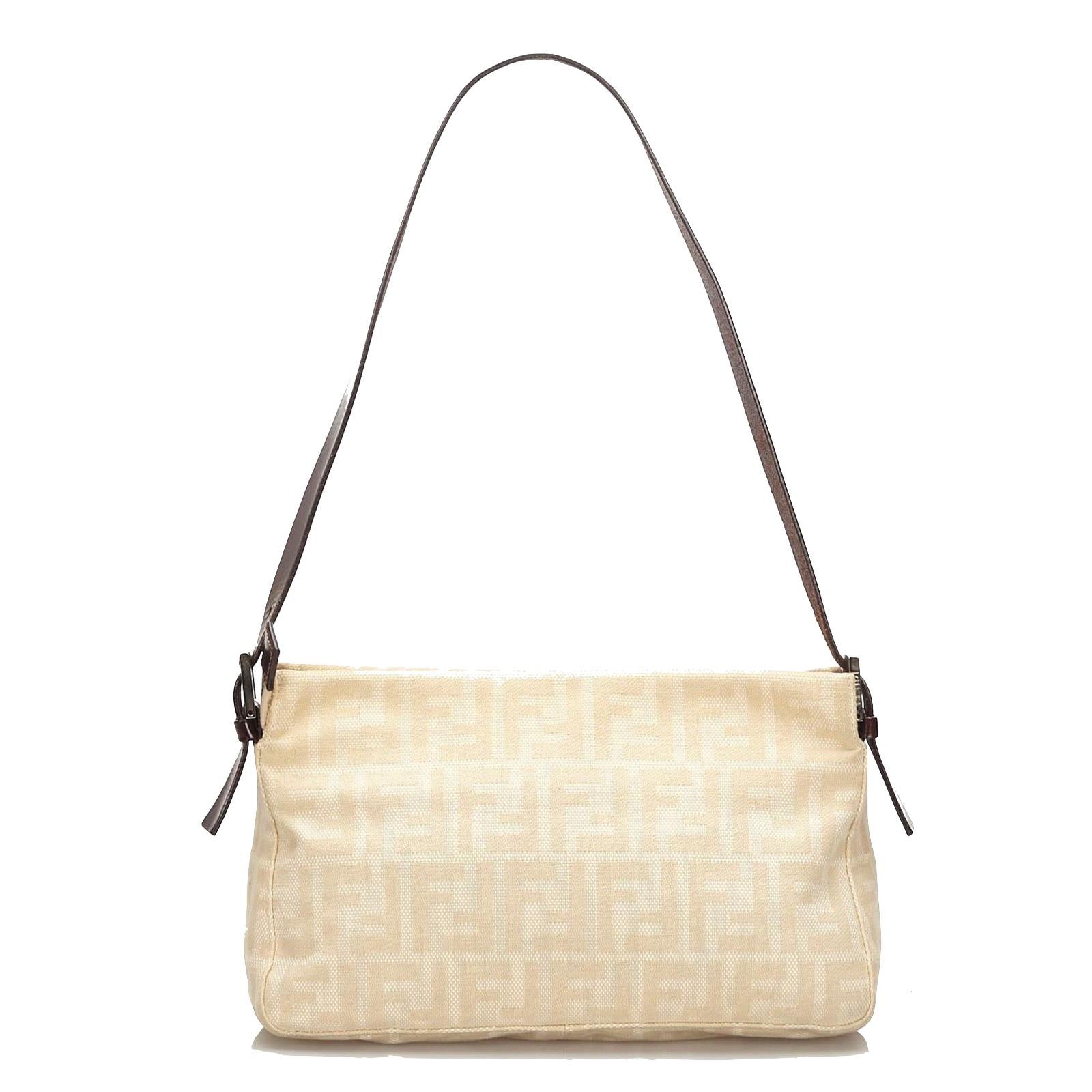 Esta baguette está hecha de lona de color beige y marfil con estampado FF Zucca. La bolsa tiene un  bandolera de piel, adornos de piel, solapa delantera y herrajes plateados. La solapa se abre con cierre a presión a un interior de tela marrón con un