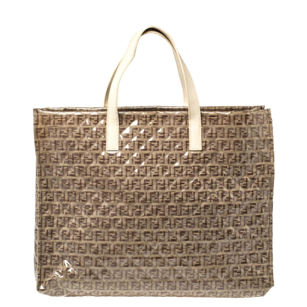 This Fendi tote is an example of the brand's magnificent designs. Crafted from PVC and Zucchino canvas in a quilted design, the bag features dual flat handles and colorful tassels. The top leads to a spacious fabric-lined interior that will hold