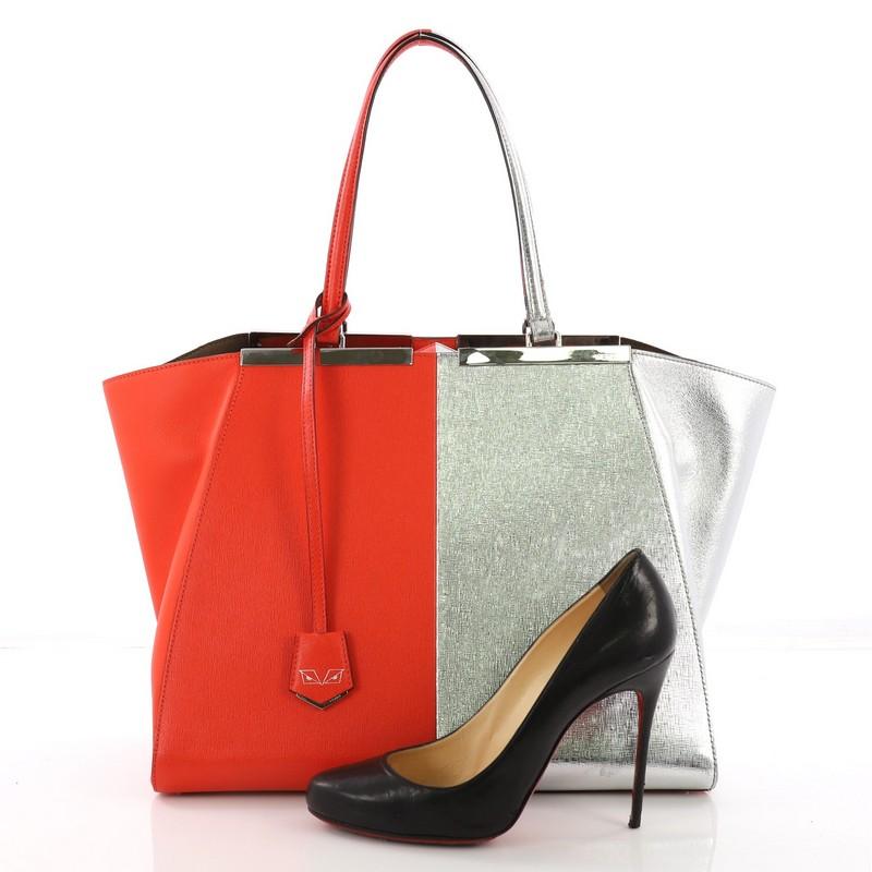 This Fendi Bicolor 3Jours Handbag Leather Large, crafted in red and silver metallic leather, features a split top bar with the Fendi brand name, tall leather handles, expanded wings, and silver-tone hardware. Its magnetic snap closure opens to a