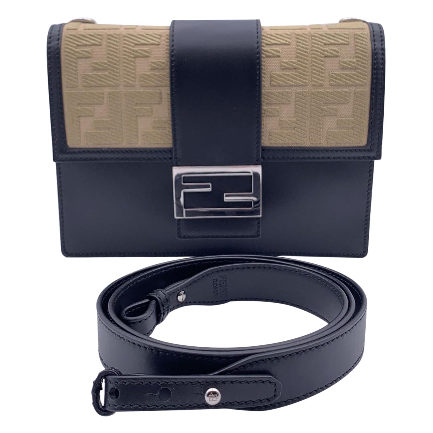 This beautiful Bag will come with a Certificate of Authenticity provided by Entrupy, The certificate will be provided at no further cost.

Fendi 'Flat Baguette' bag crafted in black leather with beige canvas flap, finished with embroidered FF motif.