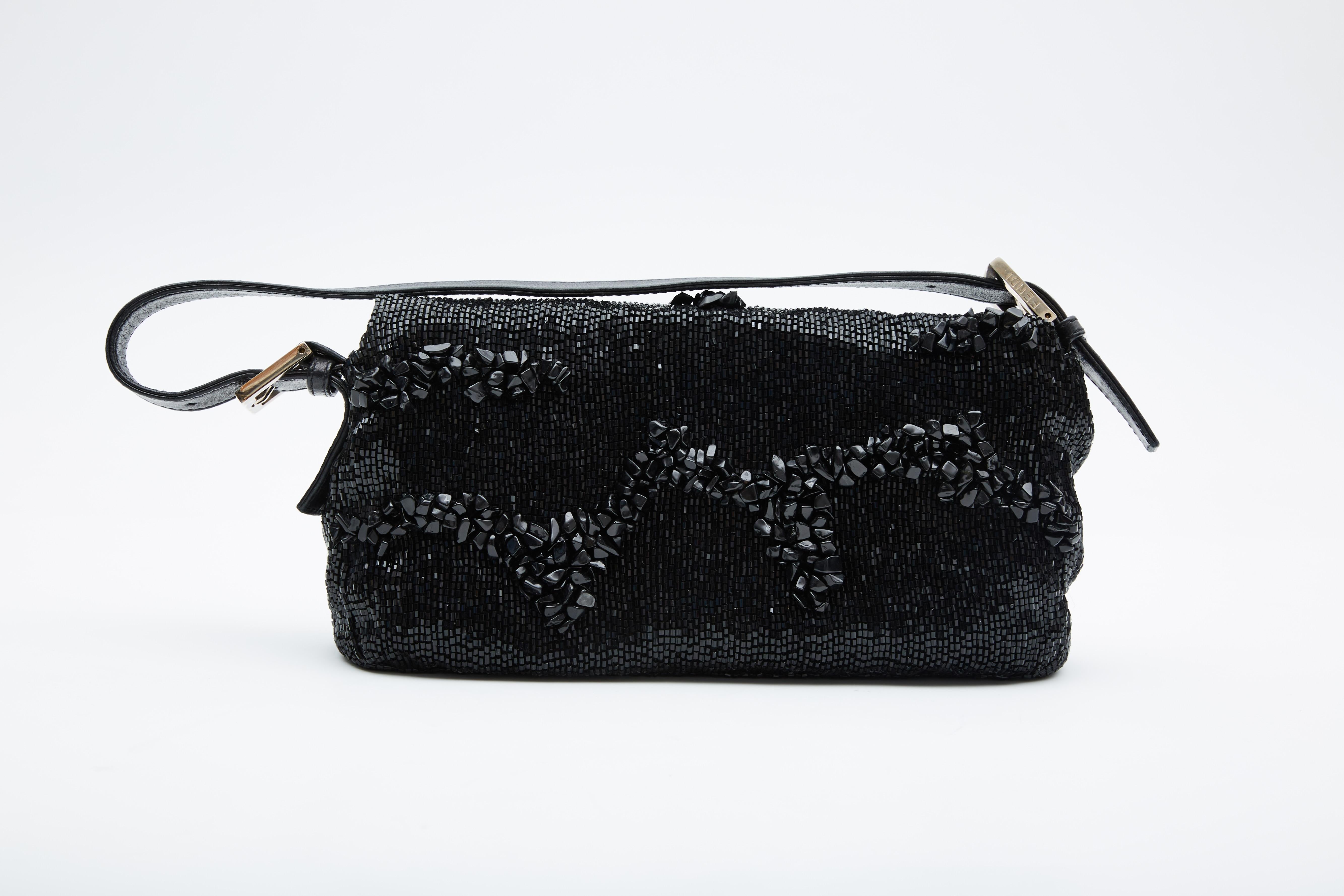 COLOR: Black
MATERIAL: Beads
ITEM CODE: Code rubbed off
MEASURES: H 6.5” x L 11” x D 2.5”
DROP: 7.5”
COMES WITH: Dust bag
CONDITION: Good - discoloration to interior with make up stains and and pen stains. Bag was refurbished professionally.

Made