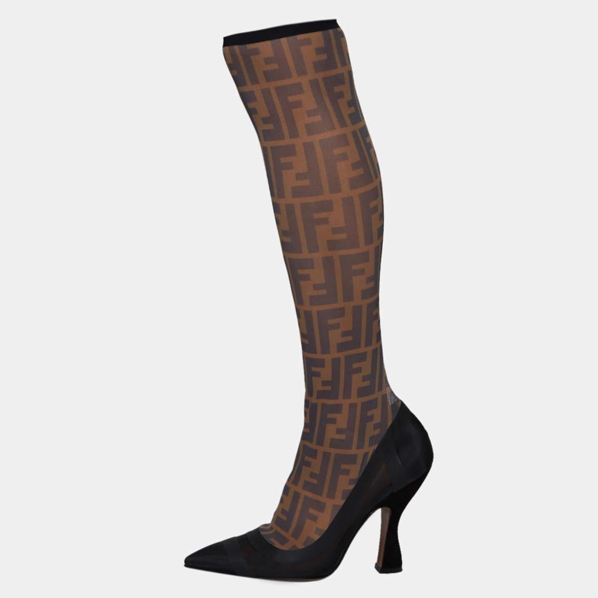 These striking and signature Colibri boots are for women who love Fendi! These knee-length boots are crafted from Zucca mesh and fabric and come in lovely hues of black & beige. The pointed toes, sleek 10.5 cm heels and leather soles add to the pair