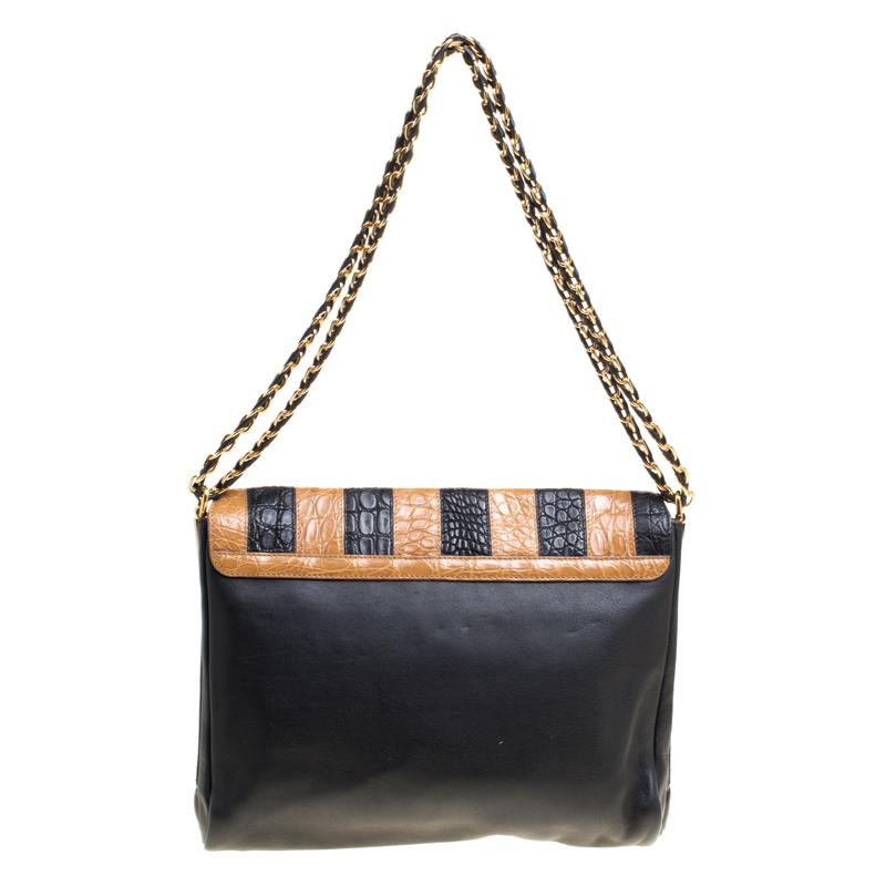 This Claudia bag by Fendi has a sophisticated look. Crafted from croc-embossed leather, the bag comes with a flap that has a striped turn lock. It is equipped with a well-sized interior and flaunts leather and chain woven straps. You can team this