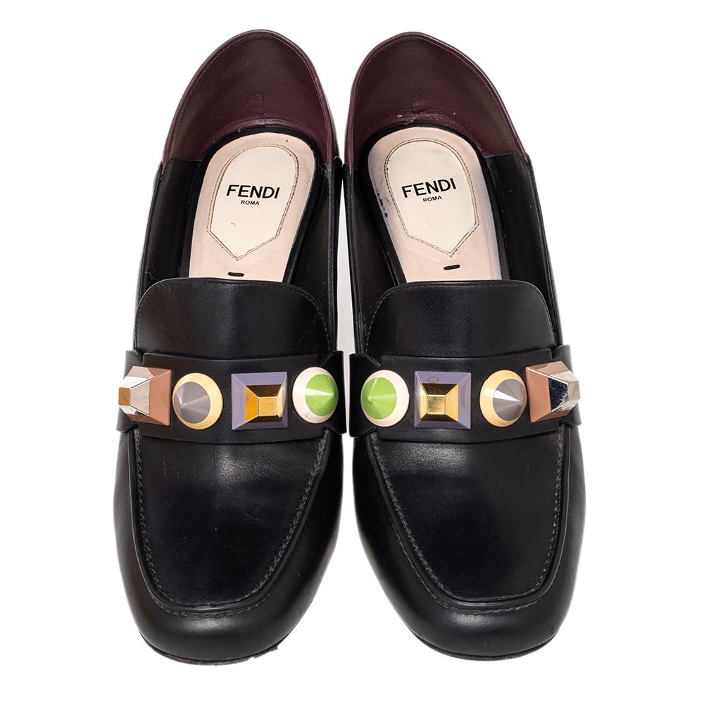 Super-comfortable and loaded with style, this pair of loafer pumps by Fendi will effortlessly complement your casual outfits or workwear. The shoes are crafted from leather and styled with stud details, covered toes, and block heels.

Includes: