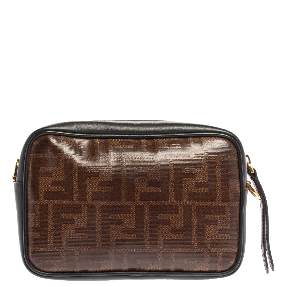 This Fendi handbag will elevate your style quotient and take it a notch higher. Carry this mini camera bag without compromising on style. This brown & black Zucca canvas & leather bag comes in a simple style with the logo on the front. This chic bag