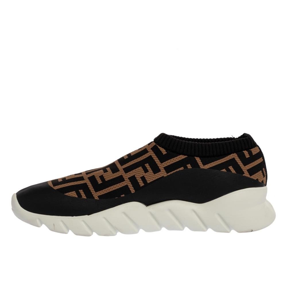 Sleek and luxe, these slip-on sneakers by Fendi will enhance your outfits by giving them an edge. Meticulously crafted from signature Zucca printed fabric, they carry fine stitching touches and have a lovely brown color. The pair is complete with