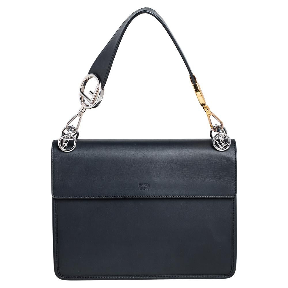 This Kan I shoulder bag from Fendi deserves a place in your luxury handbag collection. Accented with the Fendi logo in silver-toned hardware on the front flap, the Zucca velvet and leather exterior creates a subtle contrast. With a flap-type closure