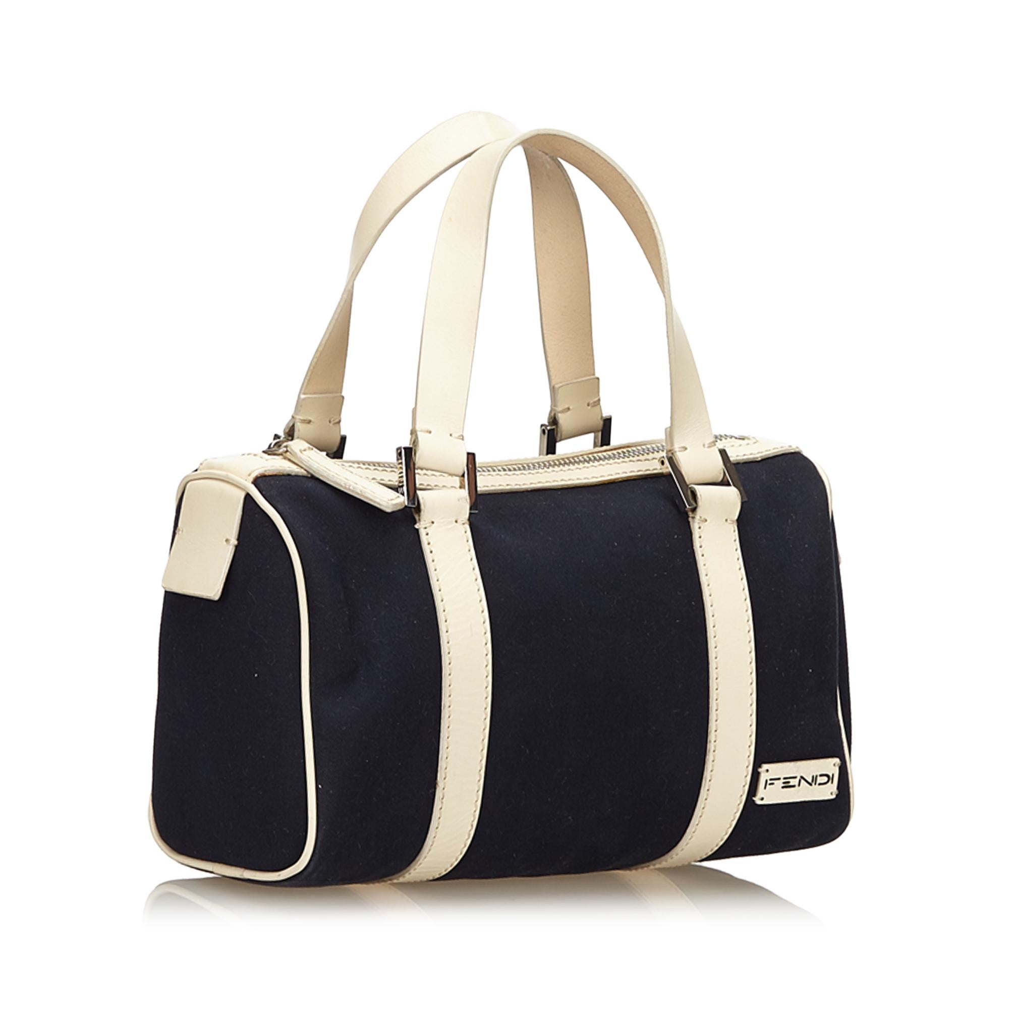 This boston bag features a canvas body with leather trim, flap leather handles, top zip closure, and an interior pocket. It carries as B+ condition rating.

Inclusions: 
This item does not come with inclusions.

Dimensions:
Length: 17.00 cm
Width: