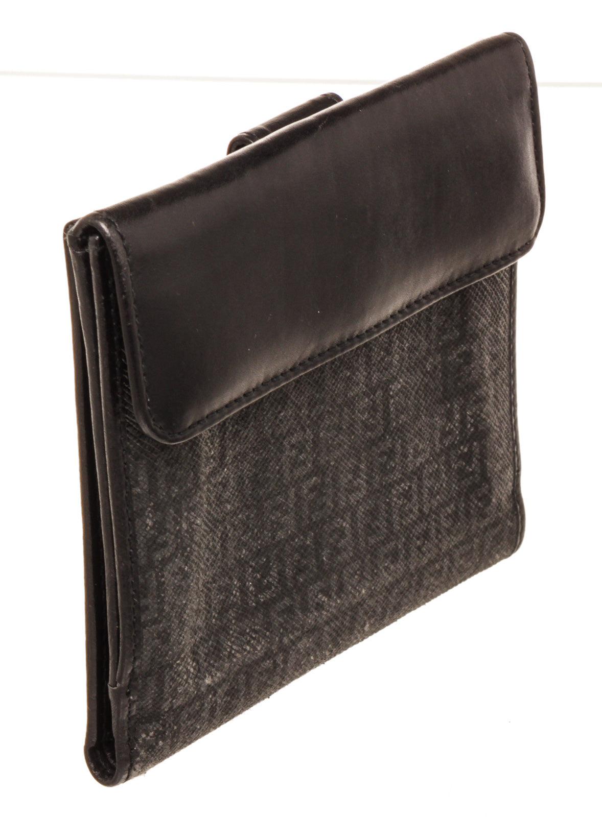 Fendi Black Canvas Compact Tab Wallet with canvas gold-tone hardware, interior card holder pockets and snap closure.
45437MSC