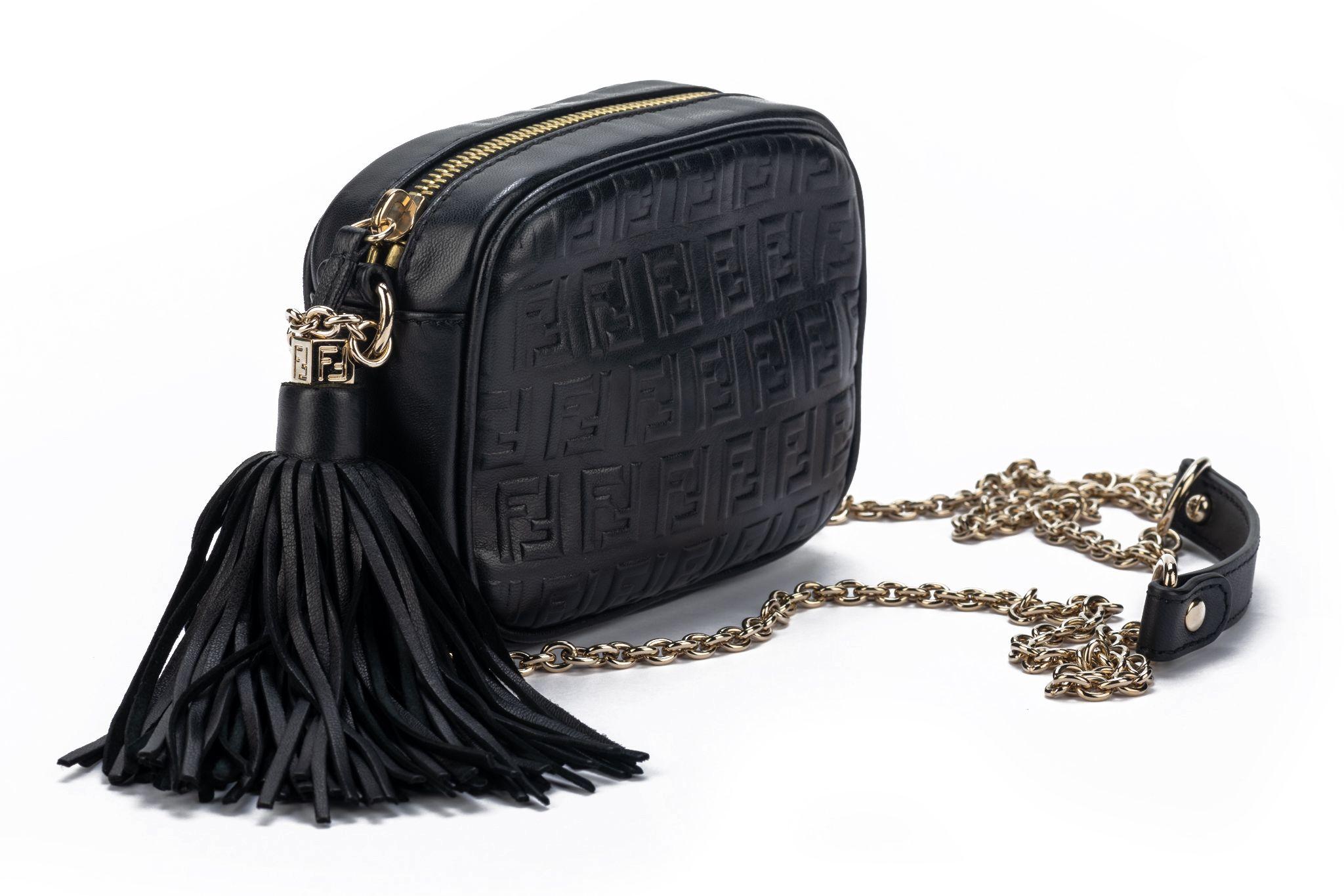 Fendi new condition black leather embossed camera bag with tassel. Shoulder cross body drop 22”. Inside fuchsia silk lining. Comes with box, booklet and dustcover
