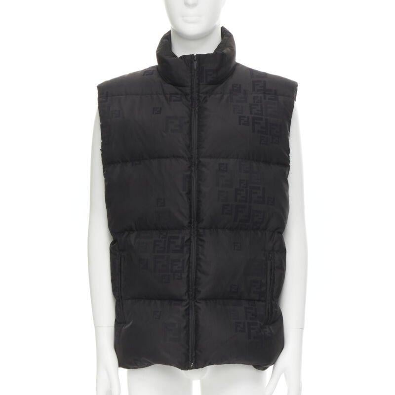 FENDI black FF Zucca monogram black goose down padded vest IT54 2XL
Reference: TGAS/C00742
Brand: Fendi
Model: FAA694 AAAS F0GME
Material: Cotton, Blend
Color: Black
Pattern: Solid
Closure: Zip
Extra Details: Black cotton-blend. FF Zucca logo