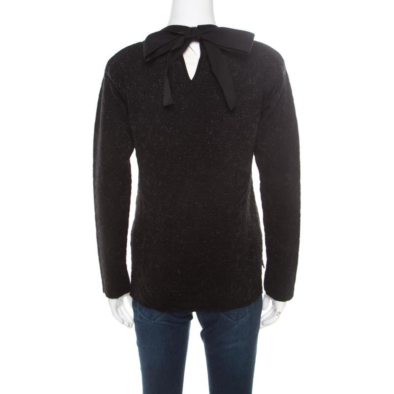 Fendi is known to create all that spells classy and modern! This black sweater is made of a wool blend and features a floral pattern. It flaunts a tie detail at the back and long sleeves. This creation can be paired with a lot of denims for a