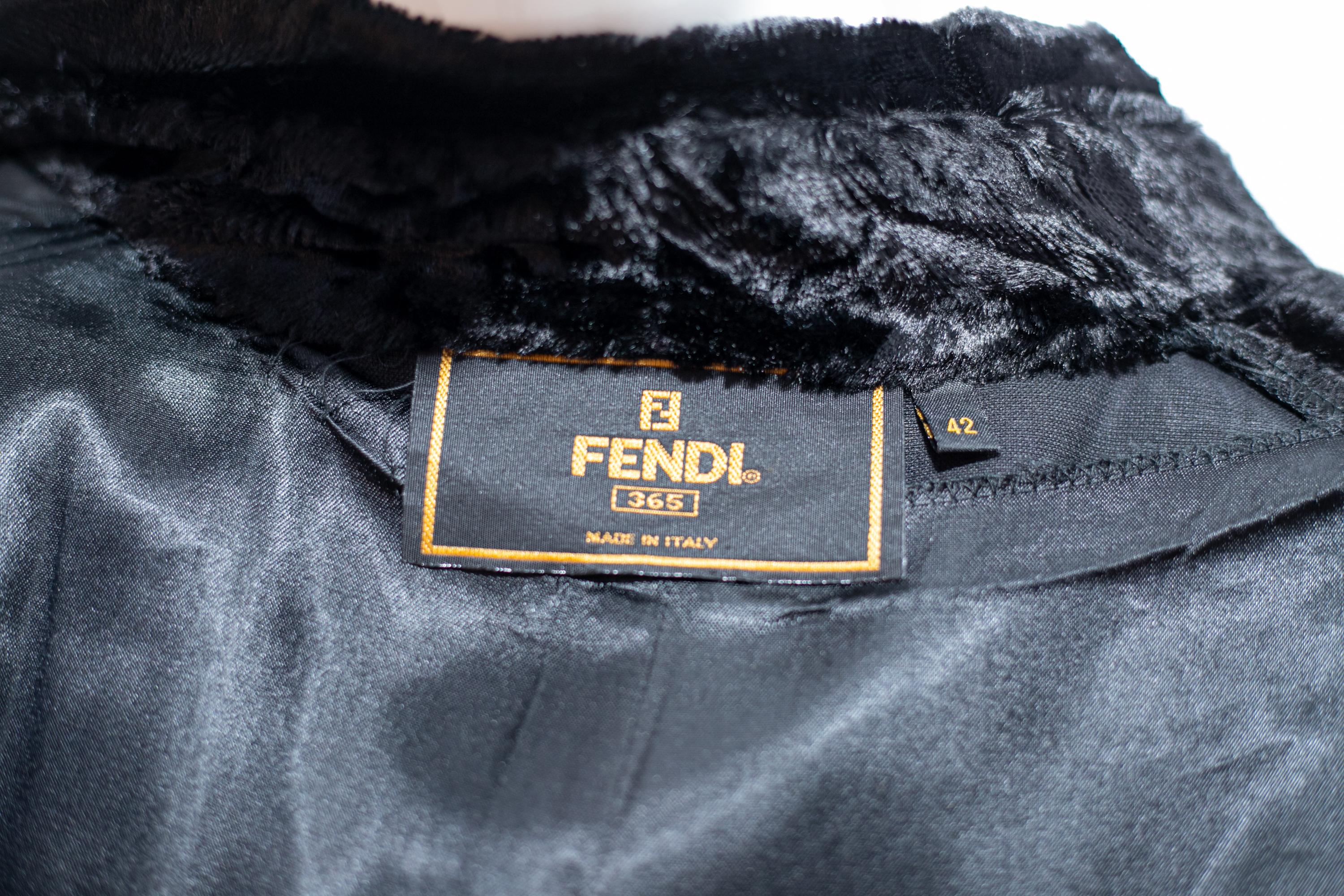 Superb black fur coat designed by Fendi in the 1980s, made in Italy. Original inner label.
The fur is entirely made of black lapin and has a substantial length, up to above the knee.
The fur has a fascinating spotted weave, which, with the effect of
