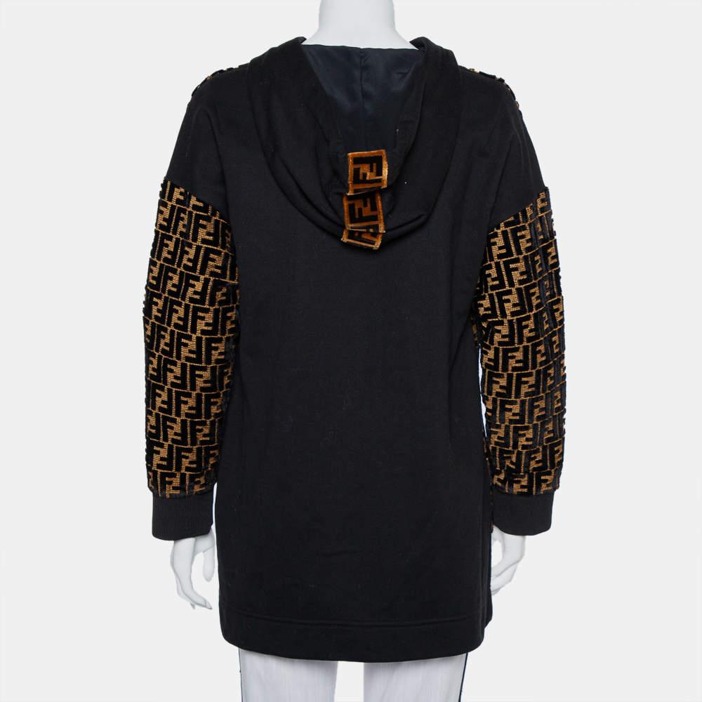 Effortlessly stylish and very trendy, this hooded sweatshirt from Fendi is a must-have in your chic wardrobe! The black and gold velvet creation is styled with FF monogram details on the front and comes with long sleeves. Pair it with distressed