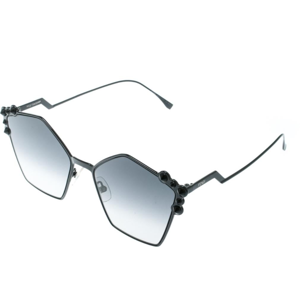 The stylish geometric silhouette is combined with gorgeous stud applications on the contours and amazingly carved metal temples, to make these Fendi sunglasses one of a kind and super fashionable. From the silhouette to the classic black hue,