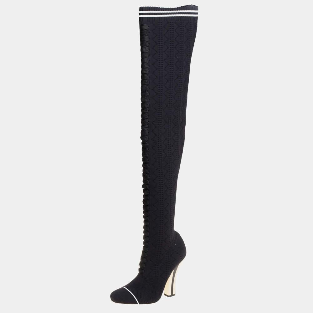 Crafted in Italy, Fendi's boots are stylish, edgy, and sporty. They are knit fabric in a sock-like silhouette adorned with laces, round toes, and a snug fit. These boots are elevated on striped 11.5 cm heels. Style them with a short dress for a