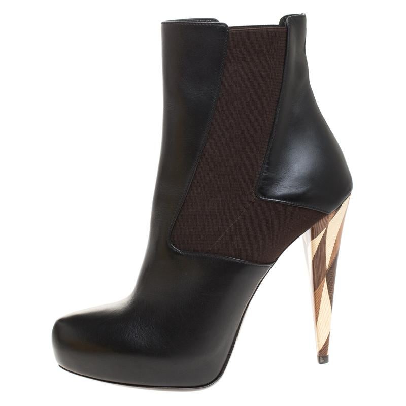 Fashioned by Fendi, these ankle boots are for fashionable souls like you. Constructed using black leather with stretchable fabric panels on the sides for easy wear, these boots are amazing. They feature platforms and 12.5 cm heels detailed with an
