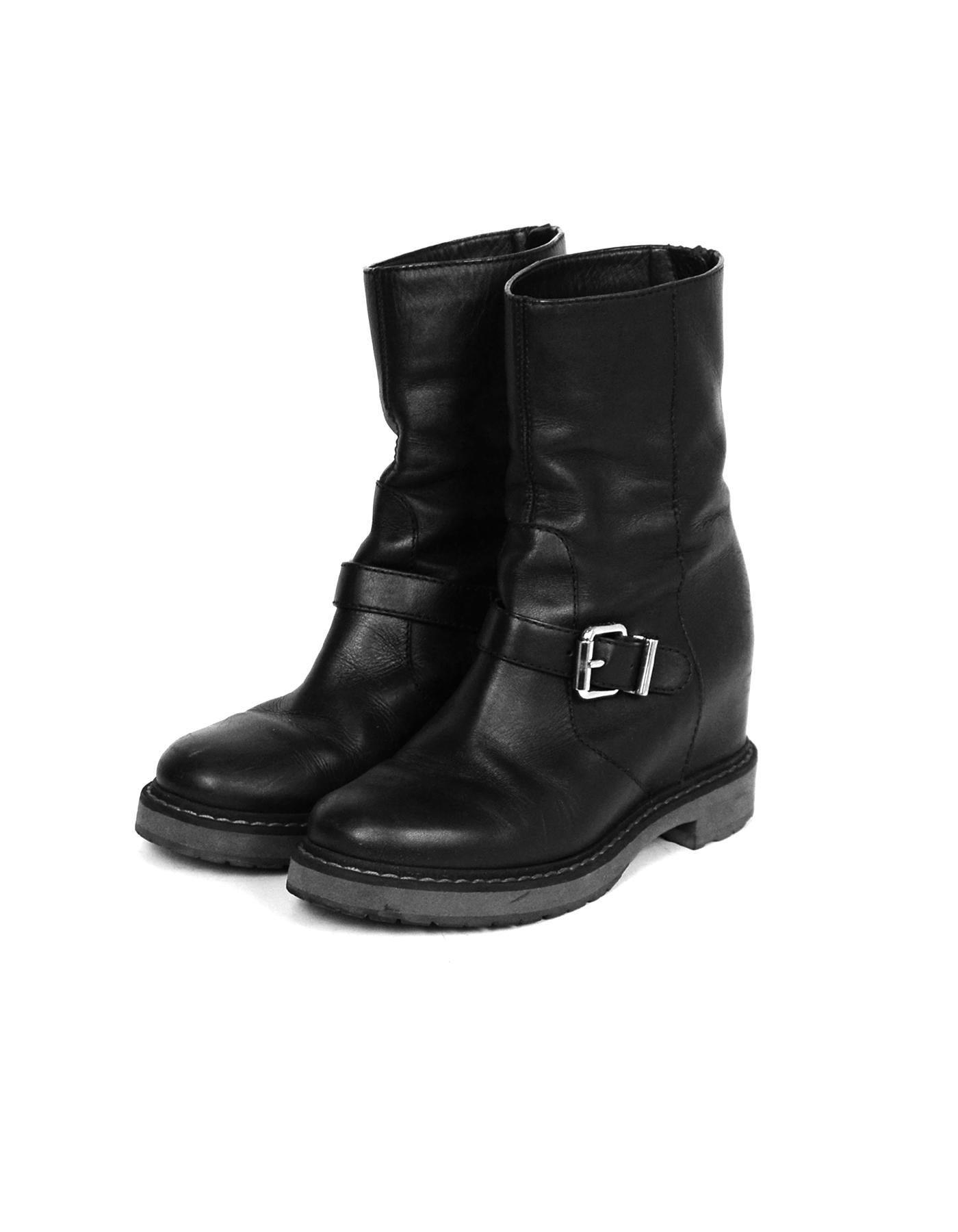 Fendi Black Leather Concealed Wedge Boot sz 38.5

Made In: Italy 
Color: Black
Hardware: Silvertone
Materials: Leather
Closure/Opening: Back zipper
Overall Condition: Very good pre-owned condition, scuffs on the exterior (see photos), wear on soles