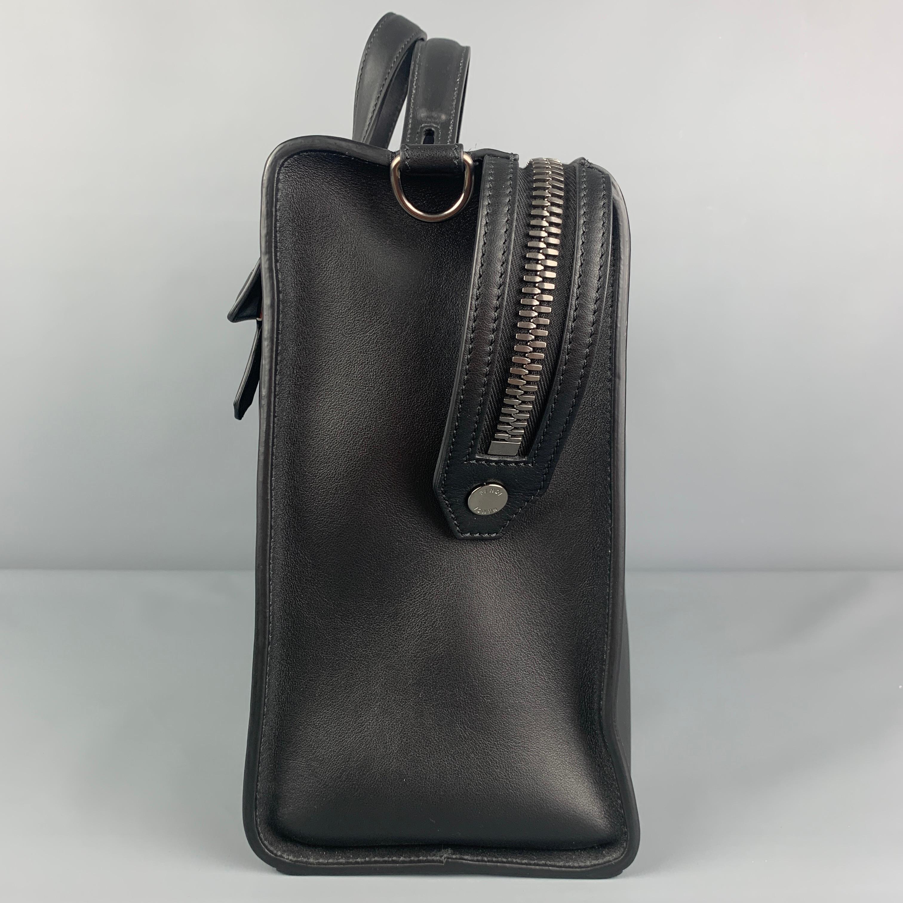 FENDI Selleria 7VA400 Briefcase comes in a black leather featuring double top handles, back exterior pocket, silver tone hardware, side snap button details, and a zipper closure. Comes with dust bag. Includes two shoulder straps. Made in Italy.
