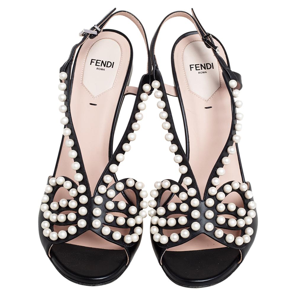 The feminine aura that these Fendi sandals emanate is before matchable. Crafted from black leather, they feature cutout details decorated with opulent faux pearls for a regal look. These sandals are secured with slingbacks and elevated on stiletto