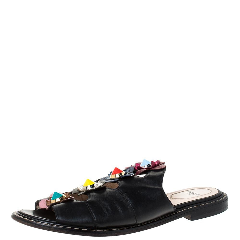 Exquisite and enchanting, these Flowerland slides from Fendi are worth every penny you spend! The black slides are crafted in Italy and made from quality leather. They feature an open toe silhouette. They've been embellished with flower motifs on