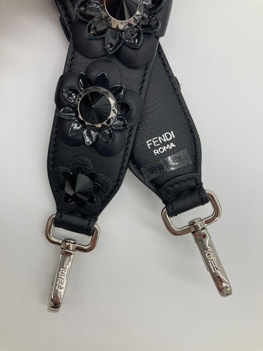 Fendi Black Leather Flowerland Strap in new without tag condition. Black leather padded strap with silver hardware. black embroidered leather flowers with two layers of petals. first layer features scalloped black leather while the top layer is